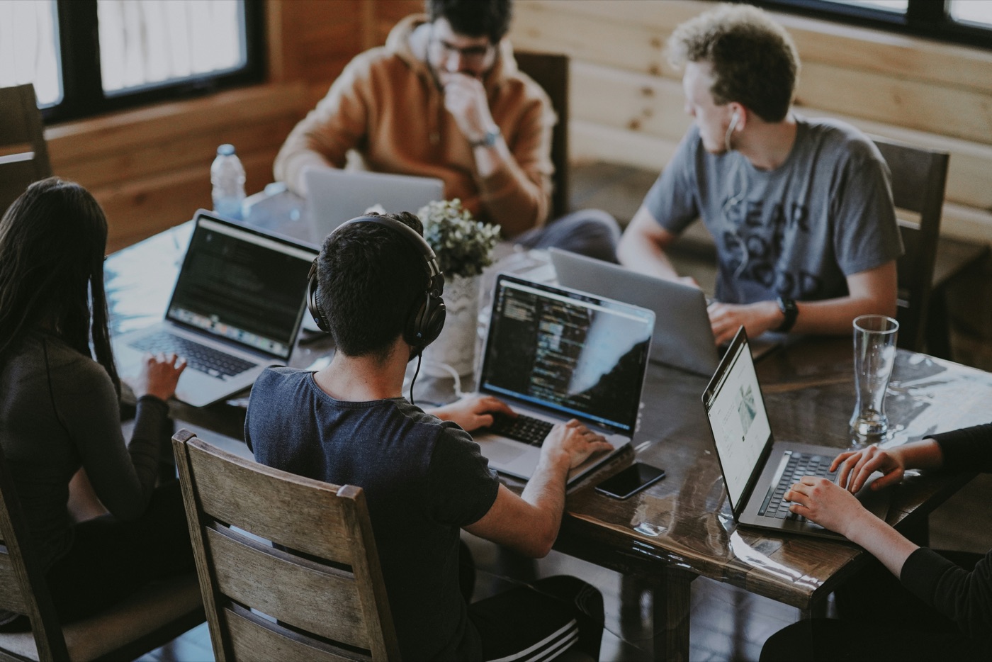 Builders on their laptops around a table